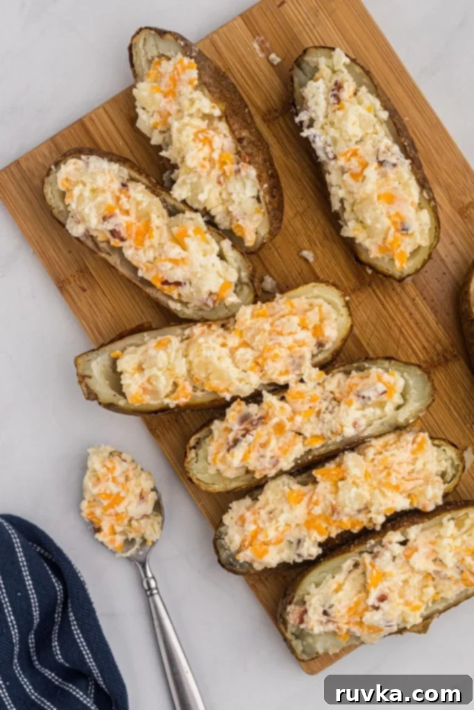 Ultimate Air Fryer Twice Baked Potatoes 6 Stuffing potato skins with mixed filling ingredients.