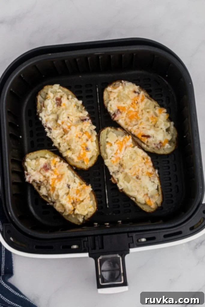 Ultimate Air Fryer Twice Baked Potatoes 7 Twice baked potato skins in the air fryer basket before being cooked