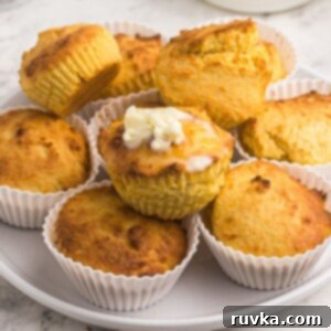Air Fryer Thanksgiving Feast Made Easy 17 Close up of cornbread muffins with top muffin covered in melting butter.
