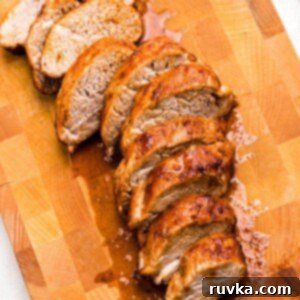 Air Fryer Thanksgiving Feast Made Easy 9 Juicy brown tenderloin cut into slices on a wooden cutting board.