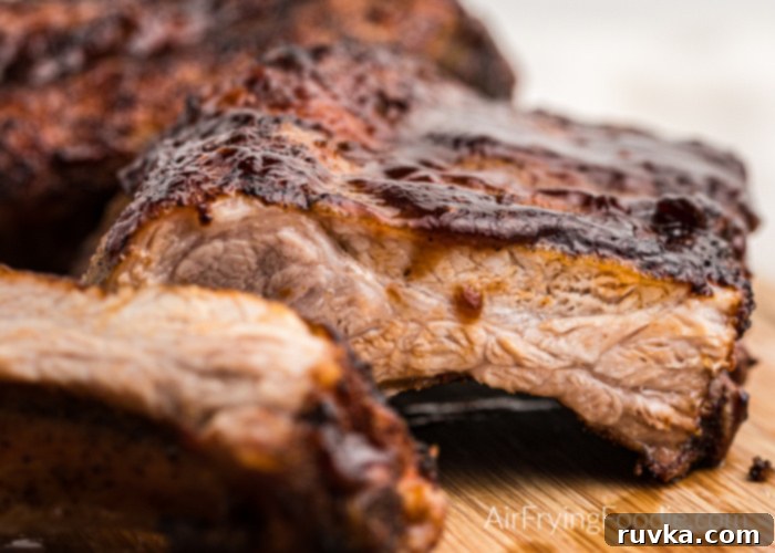 Ultimate Air Fryer BBQ Ribs 3 Delicious BBQ ribs from the Air Fryer, glistening with rich BBQ sauce and ready to serve.