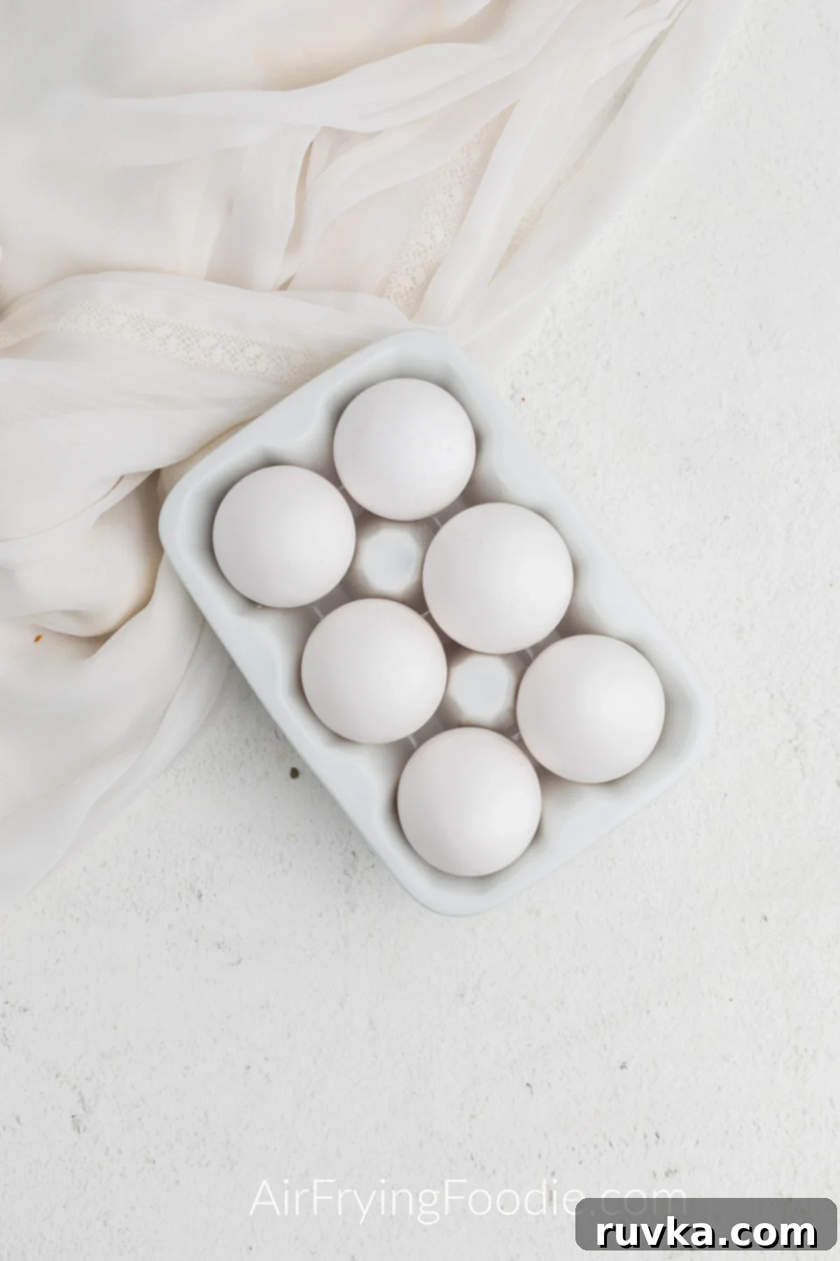 Boil-Free Hard Boiled Eggs in Your Air Fryer 3 Cold eggs ready to be cooked and in a container.