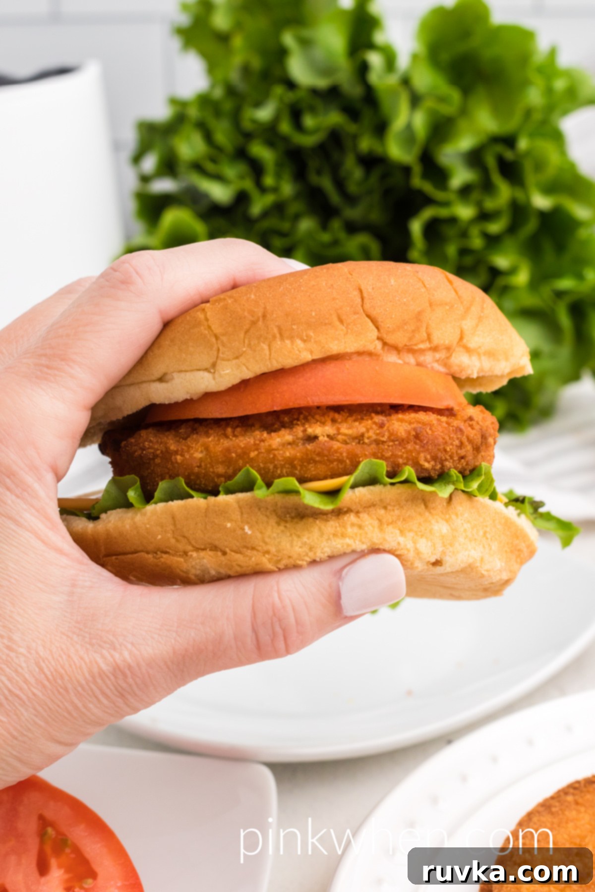 Quick and Crispy Air Fryer Frozen Chicken Patties 2 A perfectly cooked, crispy chicken patty served on a bun with fresh lettuce and tomato, made in an air fryer.