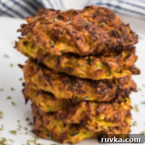 Crispy Air Fryer Zucchini Fritters 10 Close up of stacked crispy air fryer zucchini fritters.