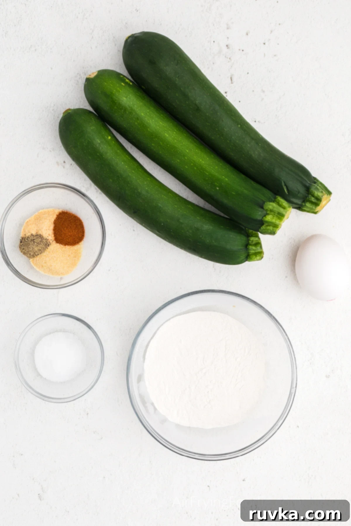 Crispy Air Fryer Zucchini Fritters 3 A collection of ingredients laid out, ready to make Zucchini fritters in the air fryer.