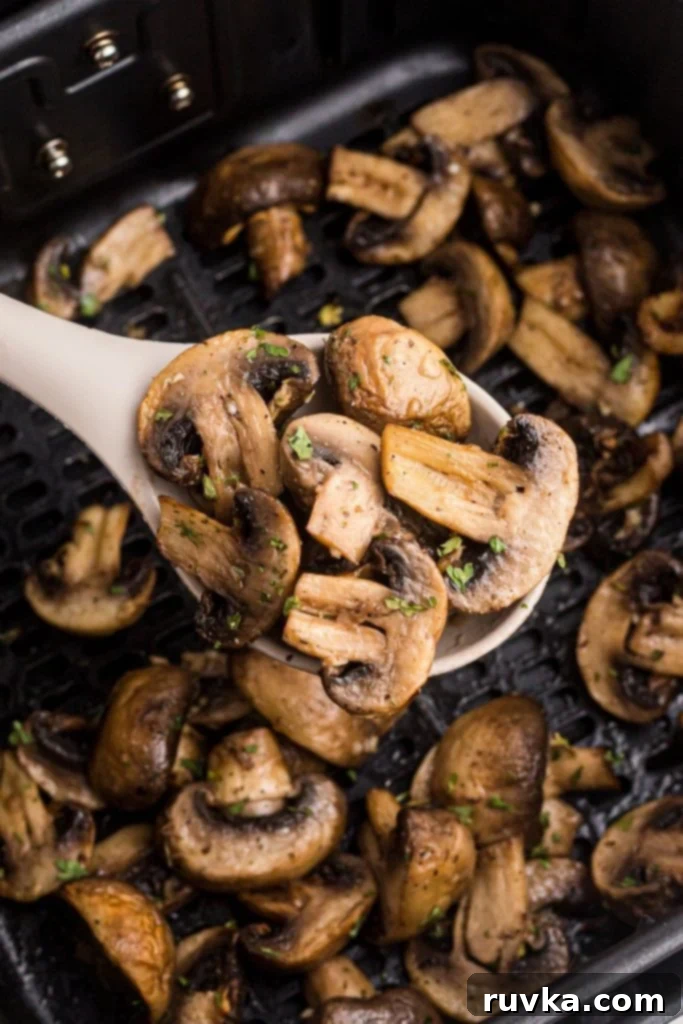 Perfectly Crispy Air Fryer Mushrooms 2 Close up photo of mushrooms after being cooked in the air fryer basket.