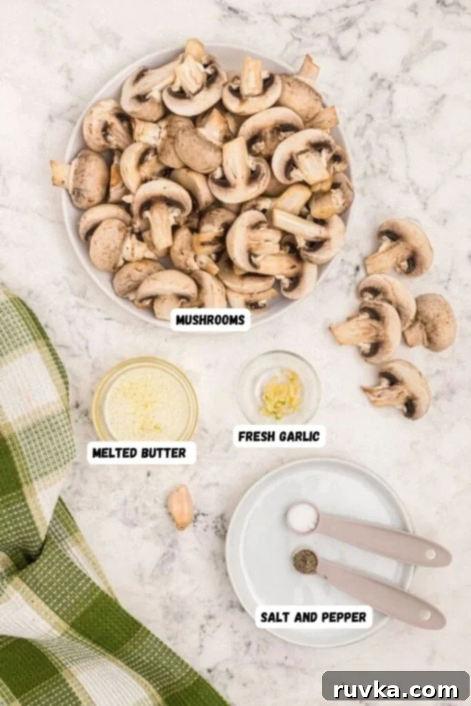 Perfectly Crispy Air Fryer Mushrooms 3 Ingredients needed to make mushrooms. Butter, garlic, salt and pepper, measured into small bowls on a white marble table.