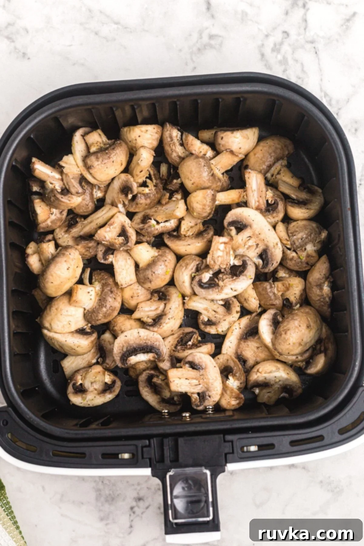 Perfectly Crispy Air Fryer Mushrooms 6 Mushrooms tossed with butter and seasonings in the air fryer basket before being cooked