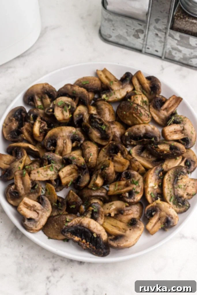 Perfectly Crispy Air Fryer Mushrooms 8 Bol of juicy cooked mushrooms seasoned with parsley flakes.