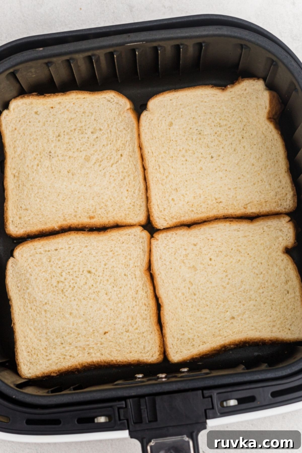 The Ultimate Air Fryer Toast 4 four slices of bread in the air fryer basket before being cooked