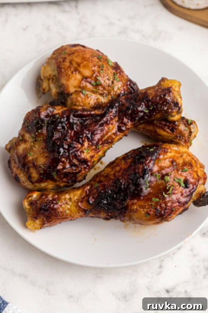 Crispy Air Fryer BBQ Chicken 3 Crispy BBQ chicken after being made in the air fryer on a white plate.