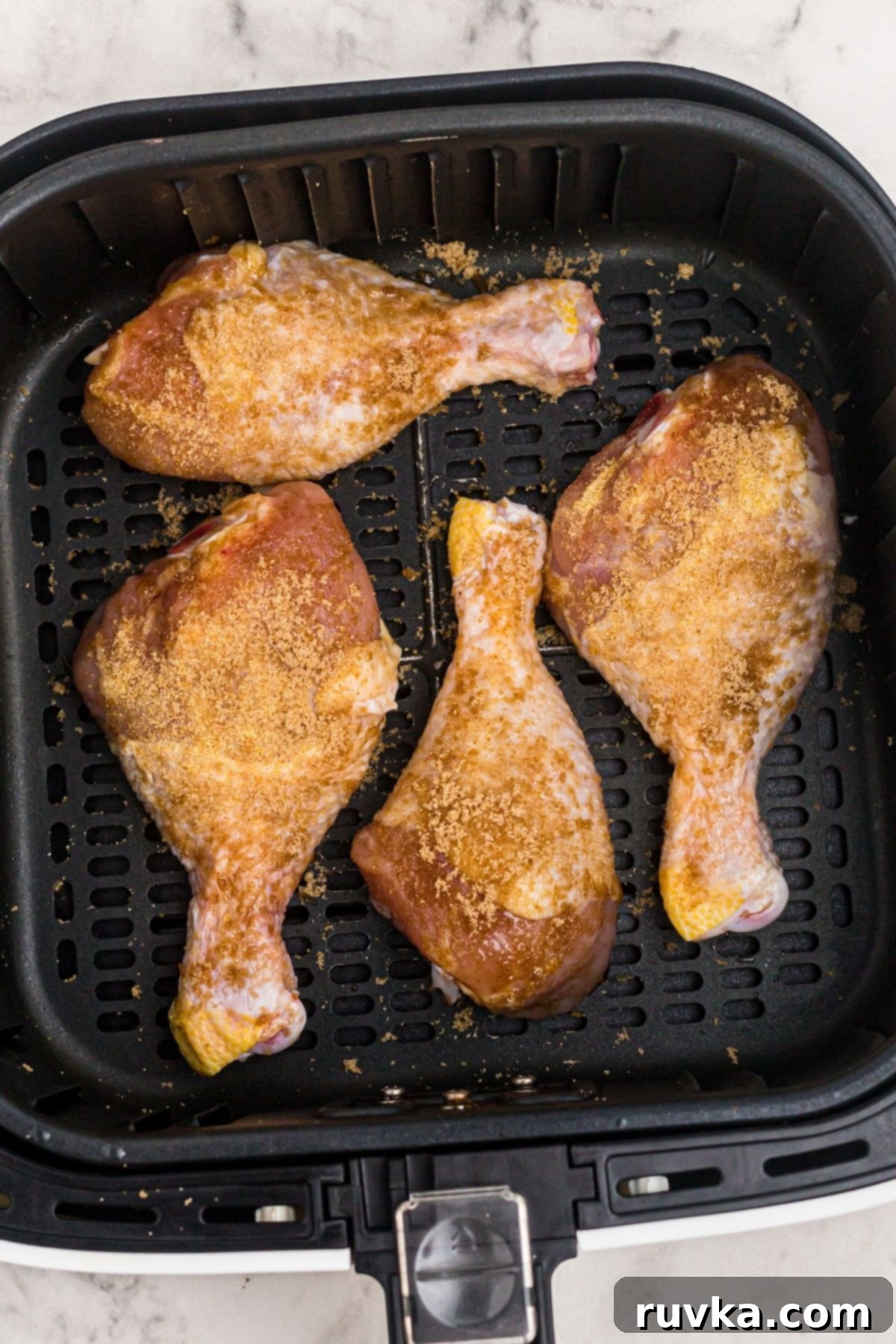 Crispy Air Fryer BBQ Chicken 5 Coated chicken with seasonings in the air fryer basket before being cooked