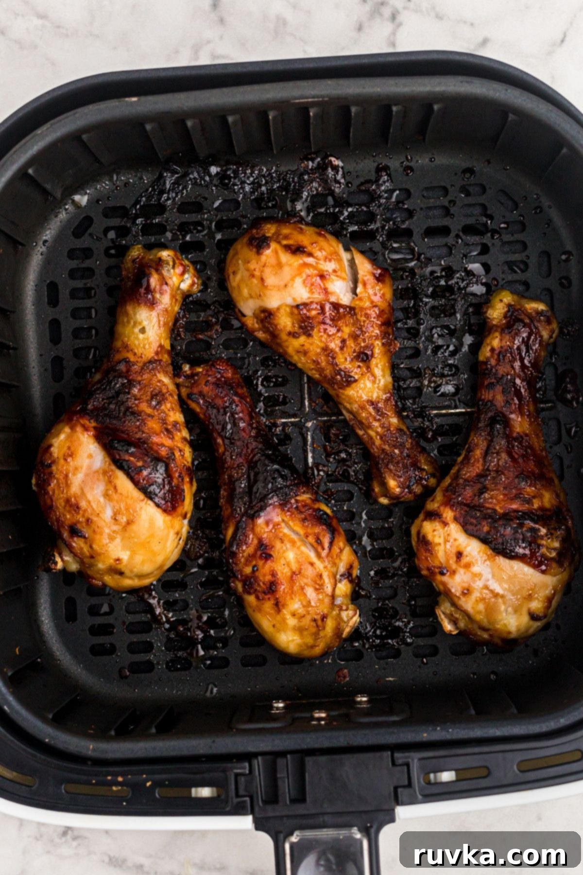 Crispy Air Fryer BBQ Chicken 6 Chicken in basket after being cooked with rub