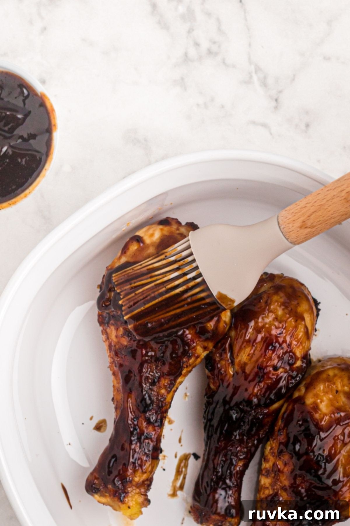 Crispy Air Fryer BBQ Chicken 7 BBQ sauce being brushed on the chicken after being cooked