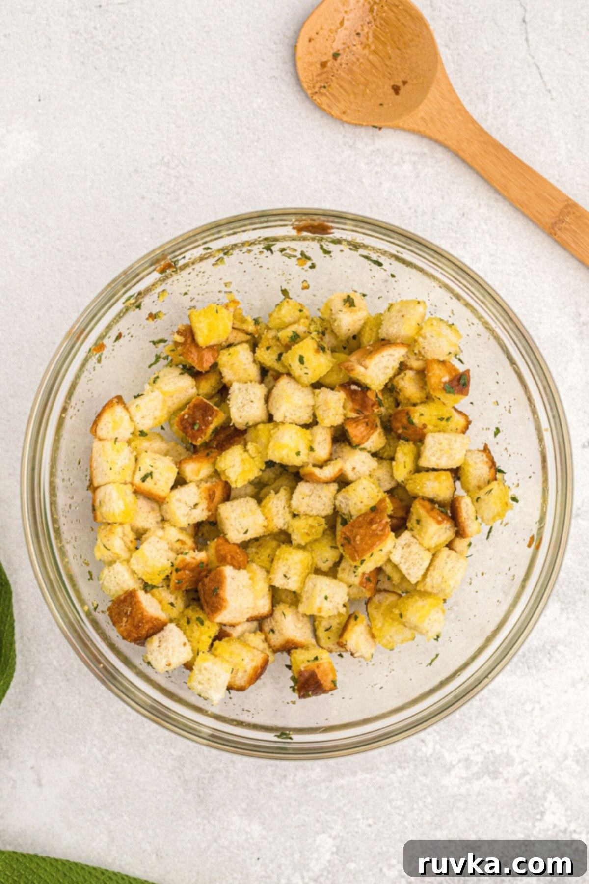 Perfectly Crispy Air Fryer Croutons 4 Bread slices cut into cubes in a clear glass bowl.