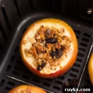 Easy Air Fryer Baked Apples 9 Golden baked apples filled with oats, raisins, nuts mixture after being cooked in the air fryer