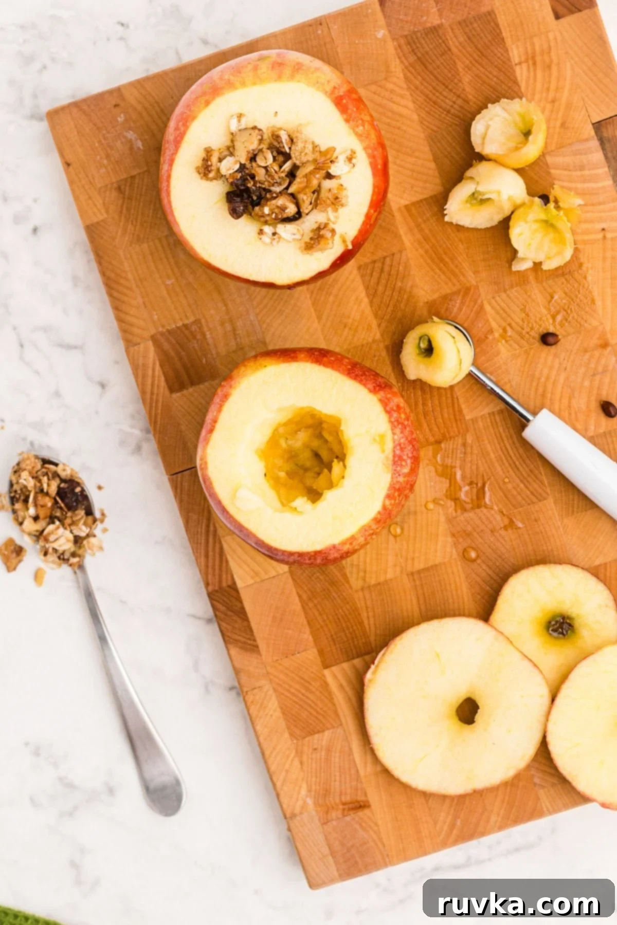 Easy Air Fryer Baked Apples 5 Apples being cored and stuffed with oat mixture before being cooked in the air fryer