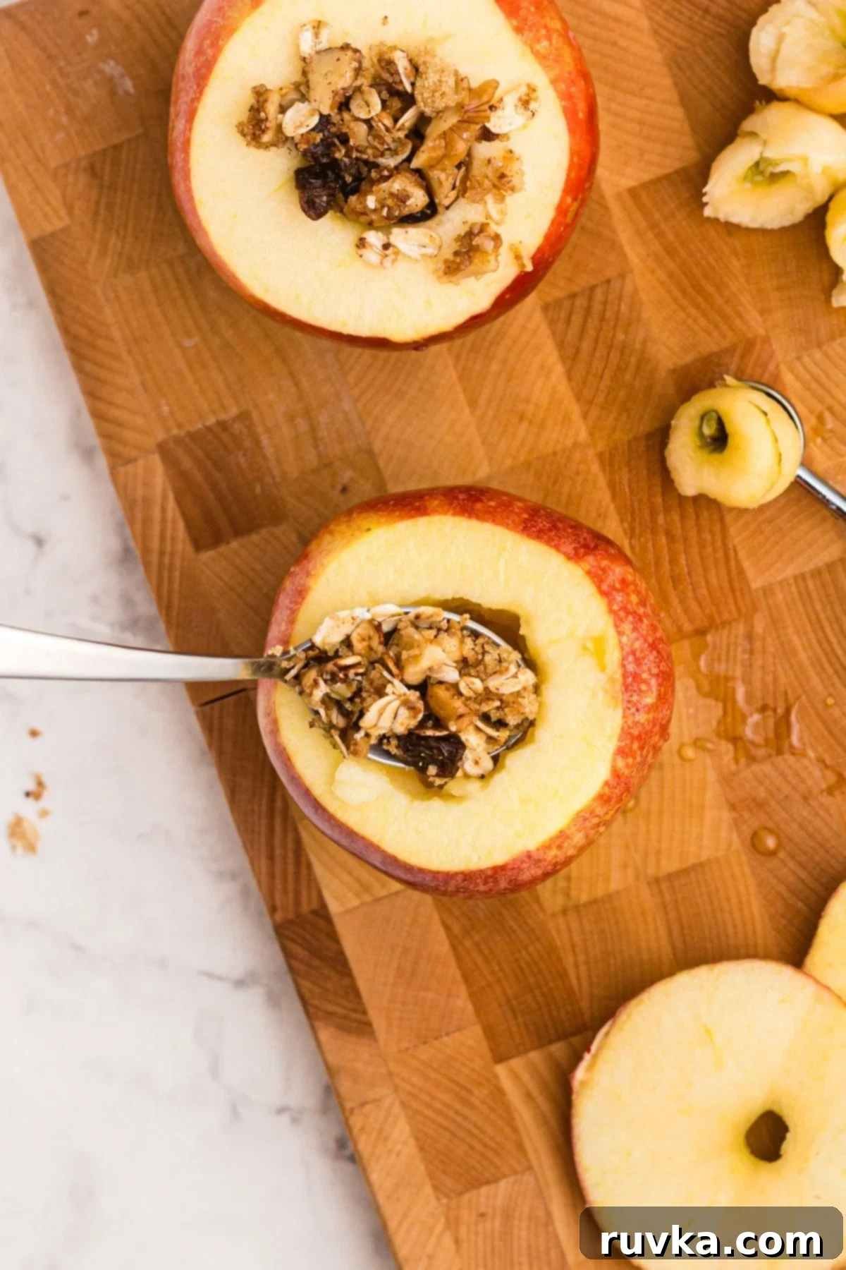Easy Air Fryer Baked Apples 6 Apples being cored and stuffed with oat mixture before being cooked in the air fryer