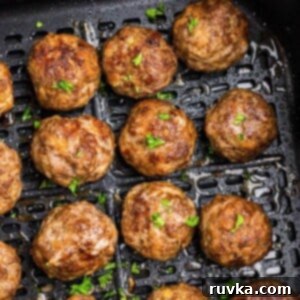 Frozen Food Favorites for the Air Fryer 12 Golden brown juicy frozen meatballs in the air fryer basket after being cooked, ready to be served.