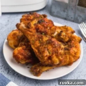 Frozen Food Favorites for the Air Fryer 20 Juicy and crispy air fryer chicken drumsticks with seasonings, served on a white plate, showcasing their golden-brown crust.