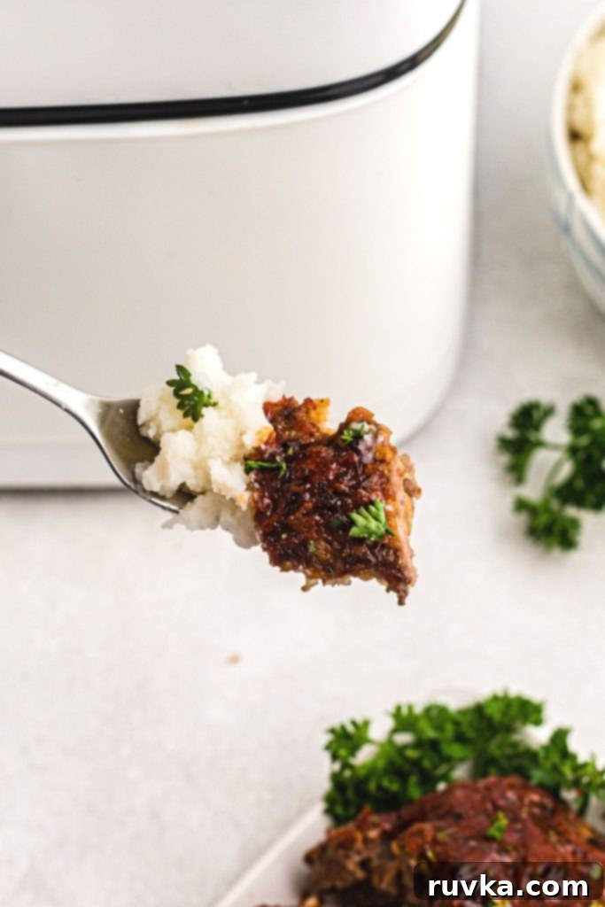 Easy Air Fryer Meatloaf 8 Fork bite of meatloaf and mashed potatoes.