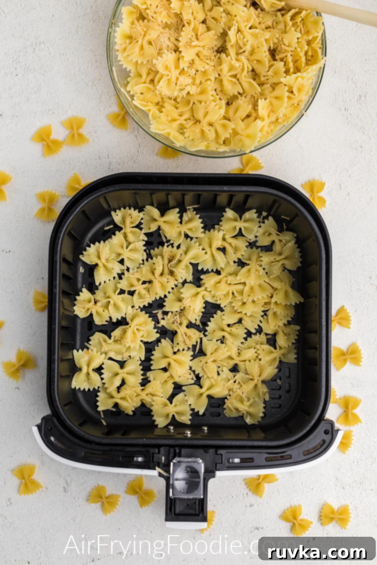 Crispy Air Fryer Pasta Chips 7 Seasoned pasta chips in a single layer in the basket of the air fryer.