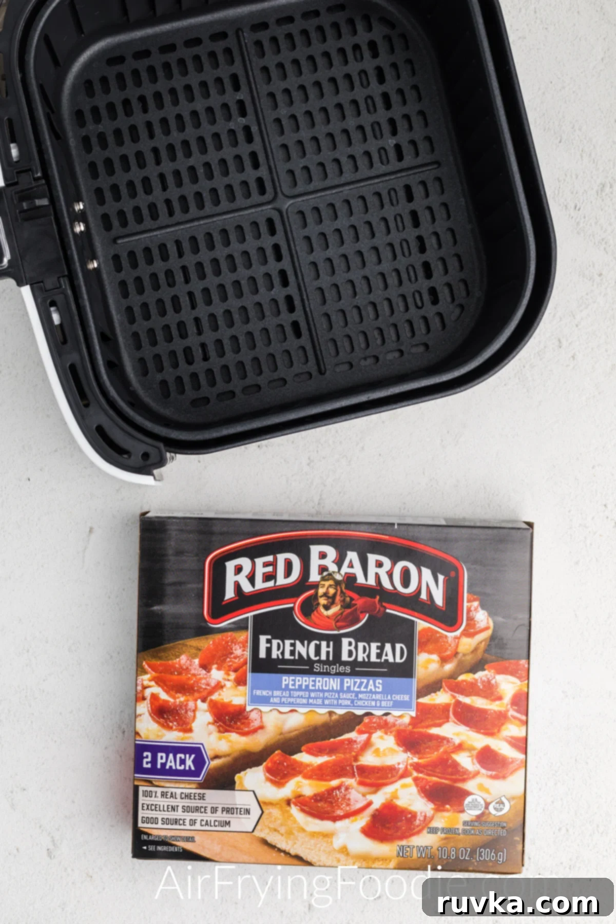 Air Fried French Bread Pizza 3 Air fryer basket and frozen french bread pizzas in a box.