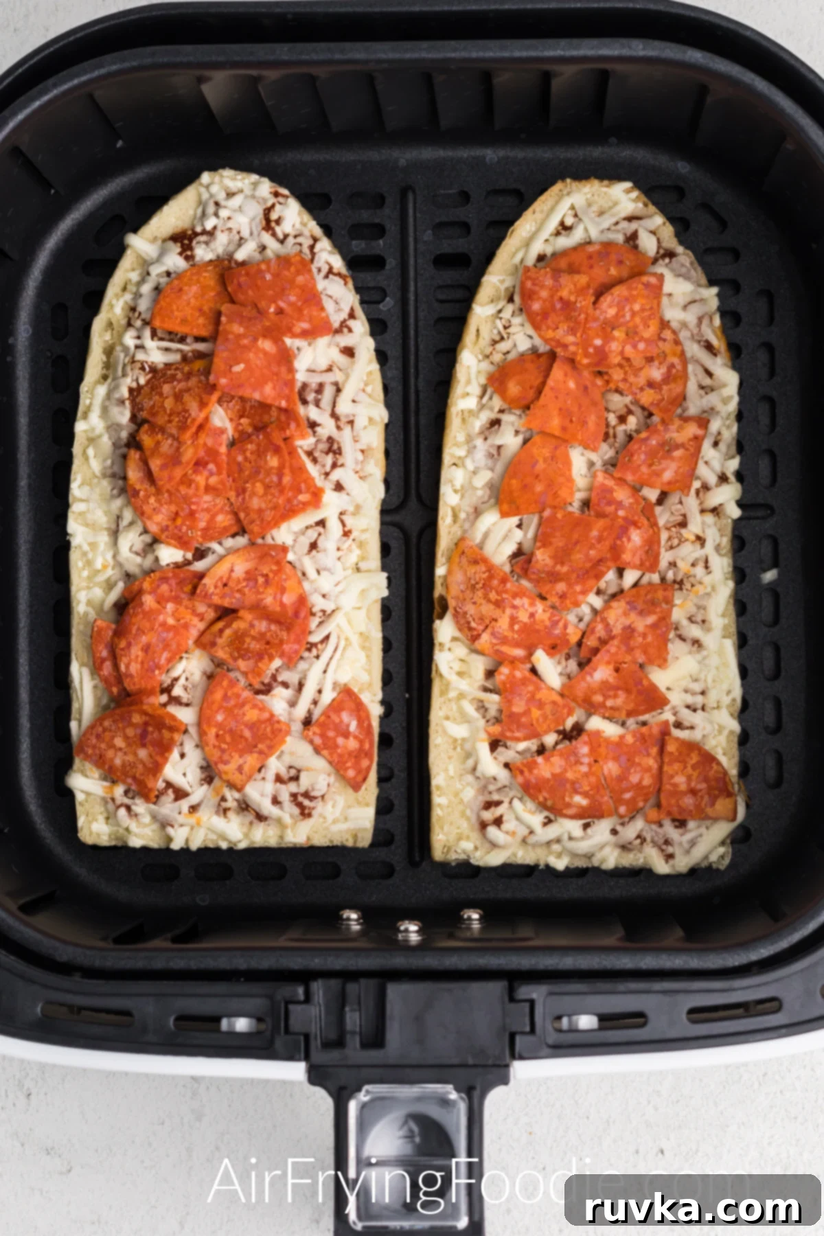 Air Fried French Bread Pizza 4 Frozen french bread pizzas in the basket of the air fryer.