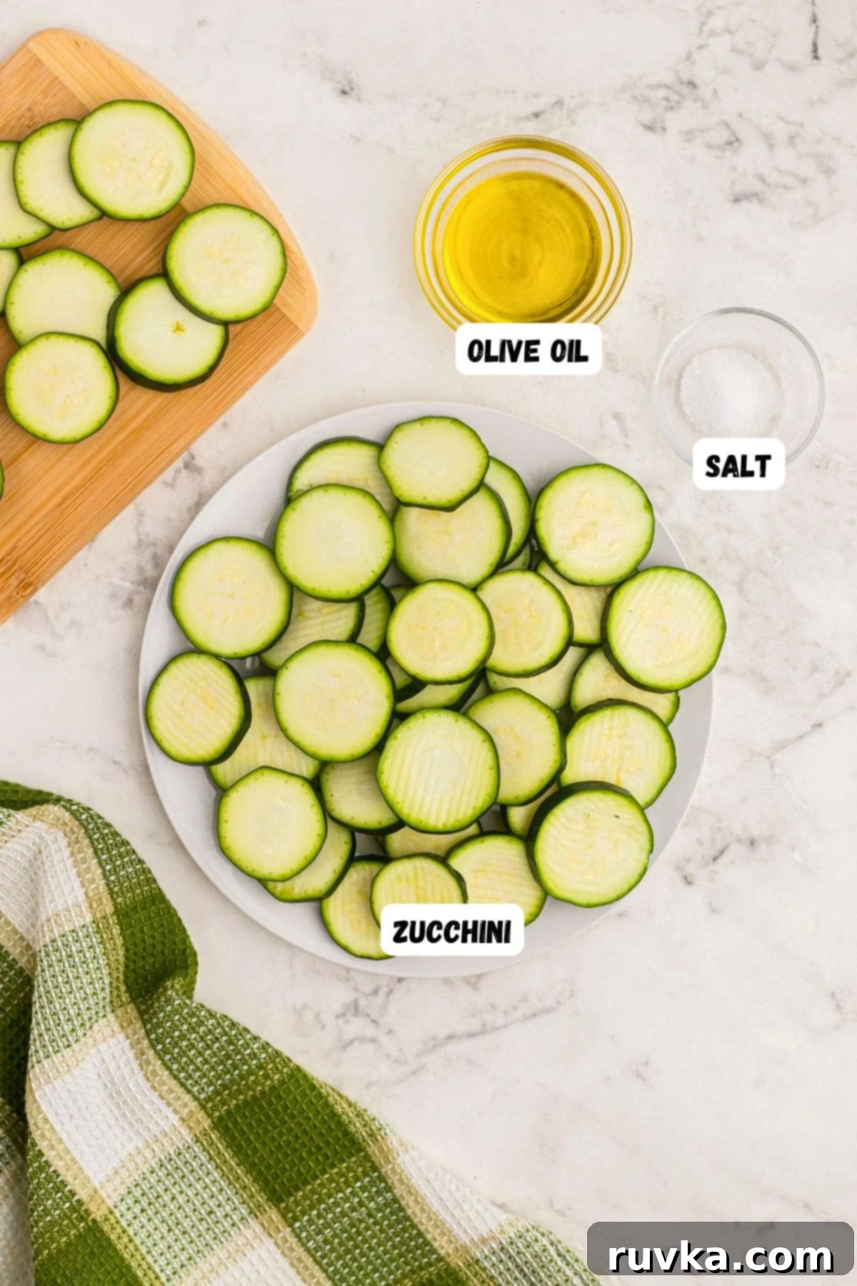 Golden Crispy Air Fryer Zucchini 3 Sliced zucchini on a wooden cutting board with olive oil and various seasonings ready for air frying.