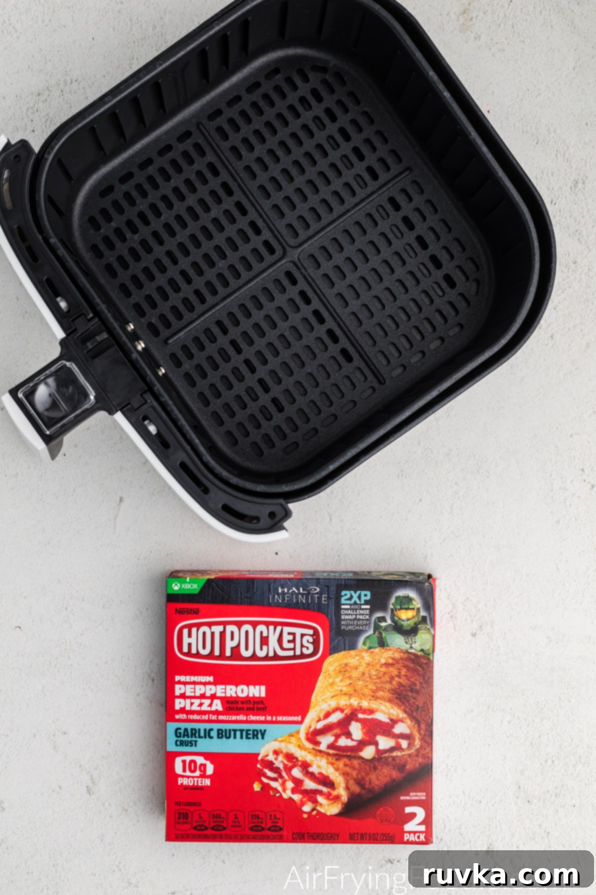 Crispy Air Fryer Hot Pockets 4 Air Fryer basket and box of frozen hot pockets.