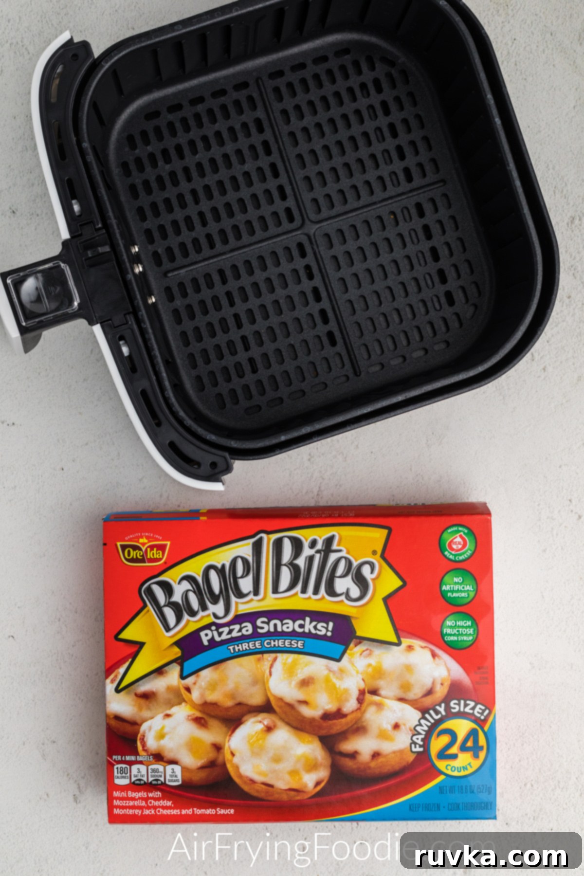 Air Fryer Bagel Poppers 3 Basket of the air fryer and a box of Ore Ida bagel bites ready to be air fried.