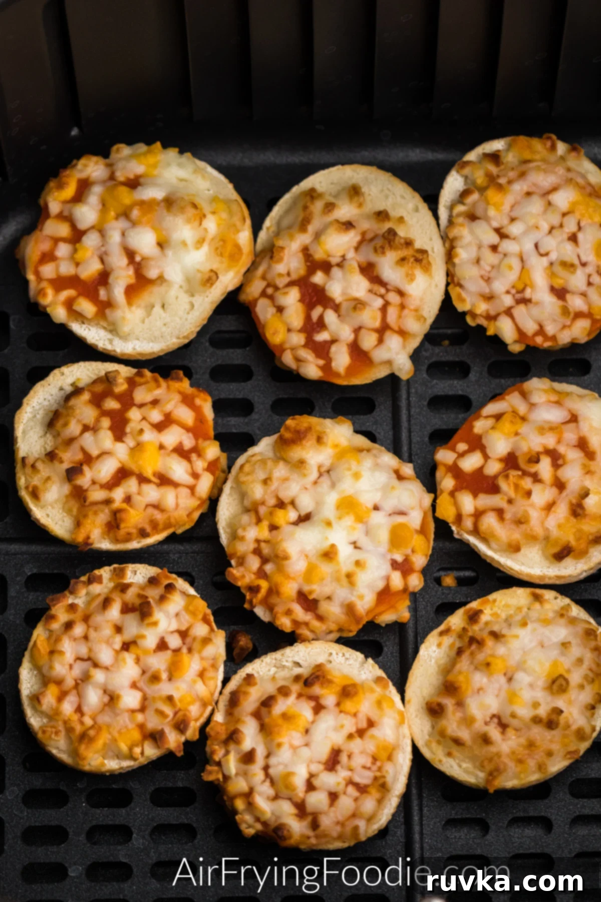 Air Fryer Bagel Poppers 5 Bagel bites in the basket of the air fryer ready to be served.