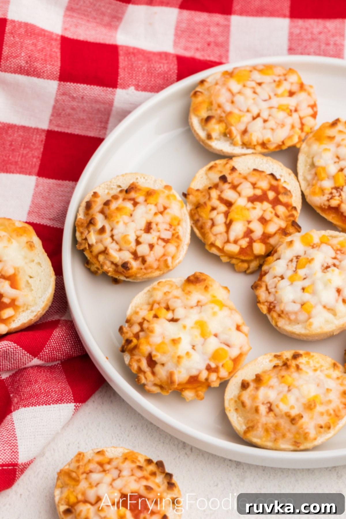 Air Fryer Bagel Poppers 6 Air Fryer Bagel Bites on a white plate ready to be served.