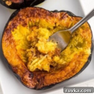 Crispy Air Fried Acorn Squash 9 Golden brown acorn squash being scooped with a fork on a white plate