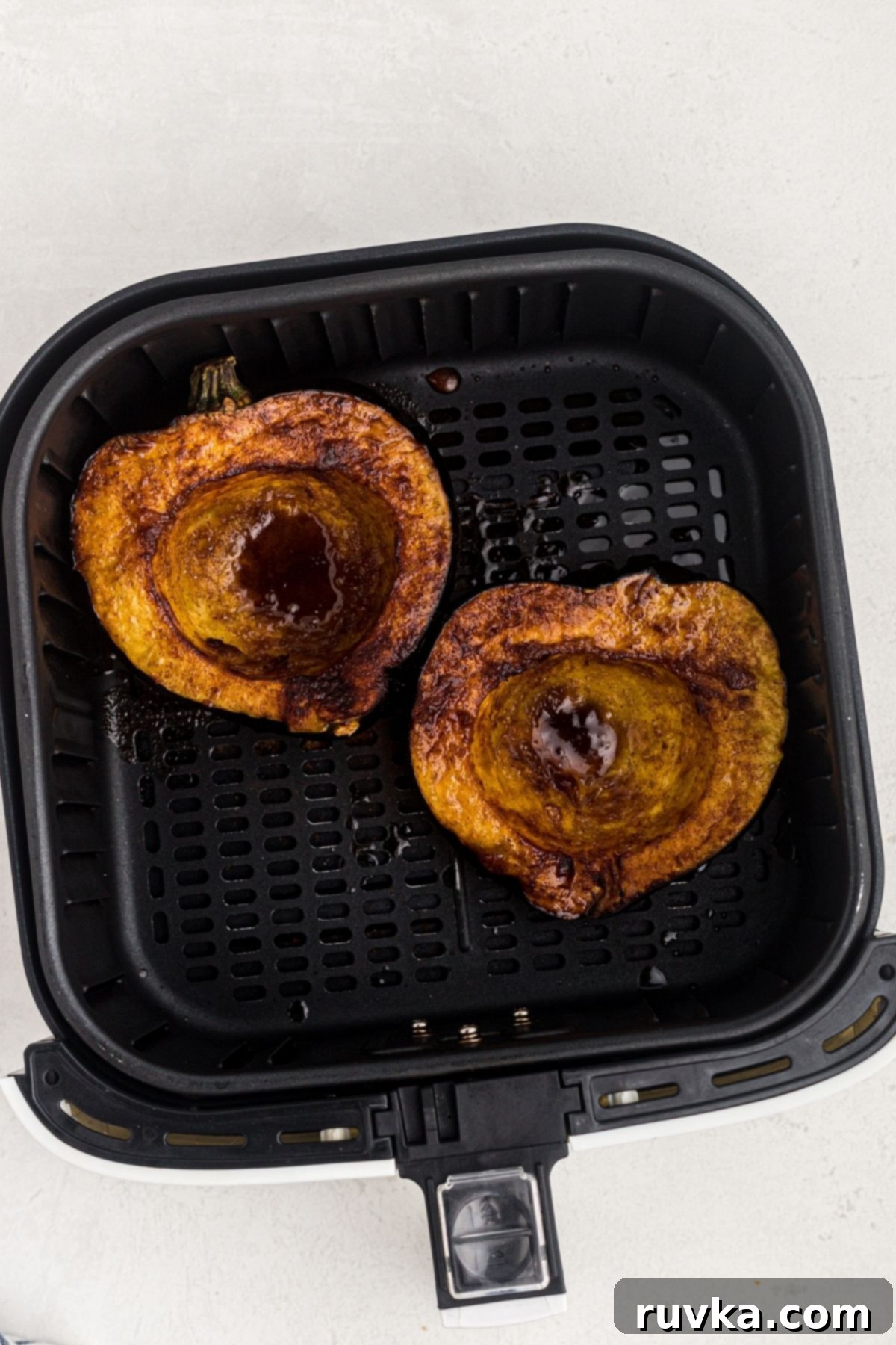 Crispy Air Fried Acorn Squash 6 Golden brown cooked acorn squash in the air fryer basket.