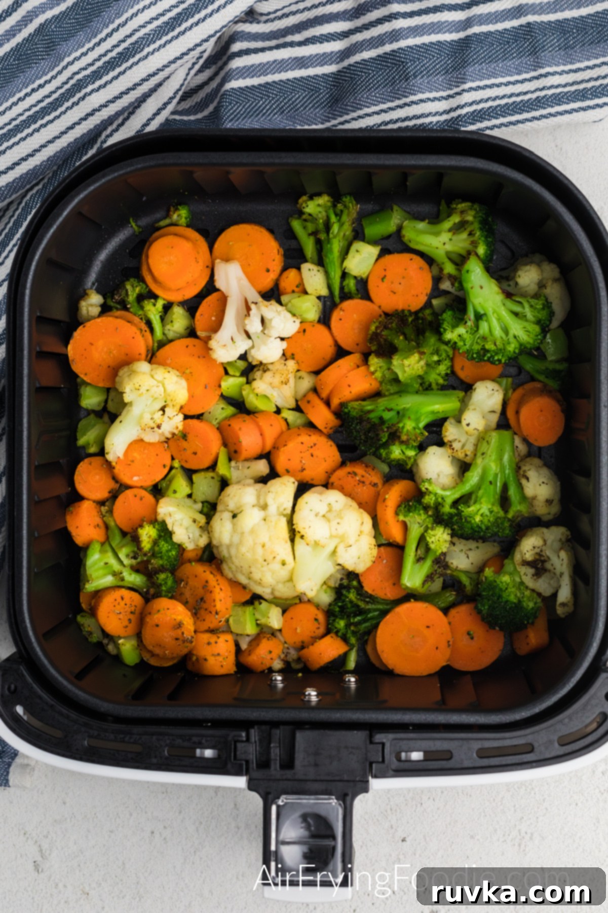 Crispy Air Fried Frozen Vegetables 5 Seasoned frozen vegetables placed in a single layer in the air fryer basket, ready for cooking.