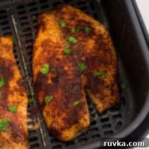 Crispy Air Fryer Tilapia 9 Golden brown cooked tilapia filets in the air fryer basket