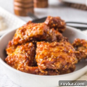 Crispy Golden Air Fryer Sesame Chicken 9 Air fried sesame chicken in a white bowl and ready to serve.