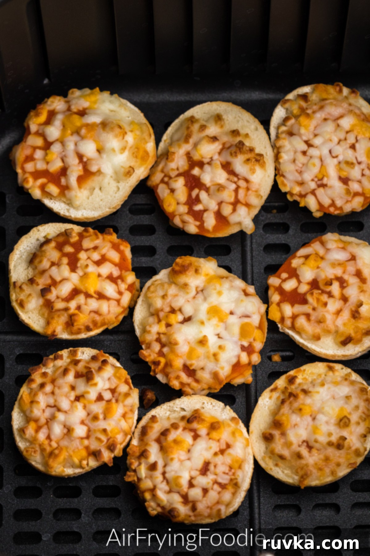 Super Bowl Air Fryer Snacks 19 Warm and cheesy bagel bites, freshly cooked in the air fryer basket, ready to be enjoyed as a quick snack.