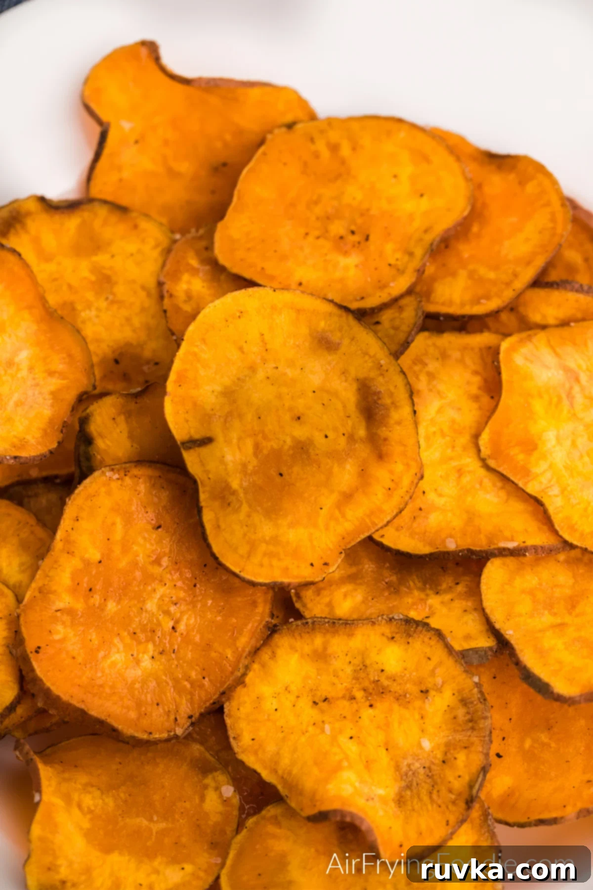 Super Bowl Air Fryer Snacks 25 Crispy sweet potato chips, seasoned and cooked in the air fryer, ready for a healthy snack.