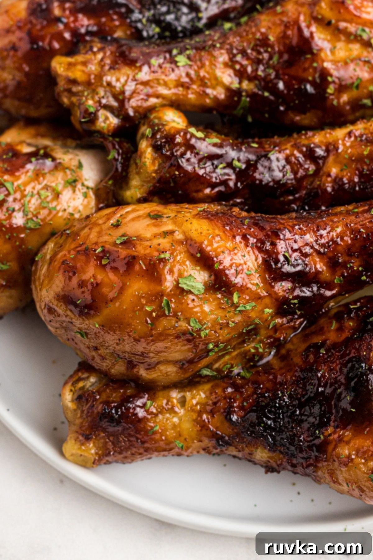 Super Bowl Air Fryer Snacks 10 Flavorful air-fried BBQ chicken pieces, glazed and served on a pristine white plate, ready for a satisfying meal.