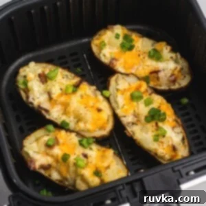 Crispy Air Fryer Veggies 15 Close up photo of twice baked potatoes after being cooked in the air fryer basket