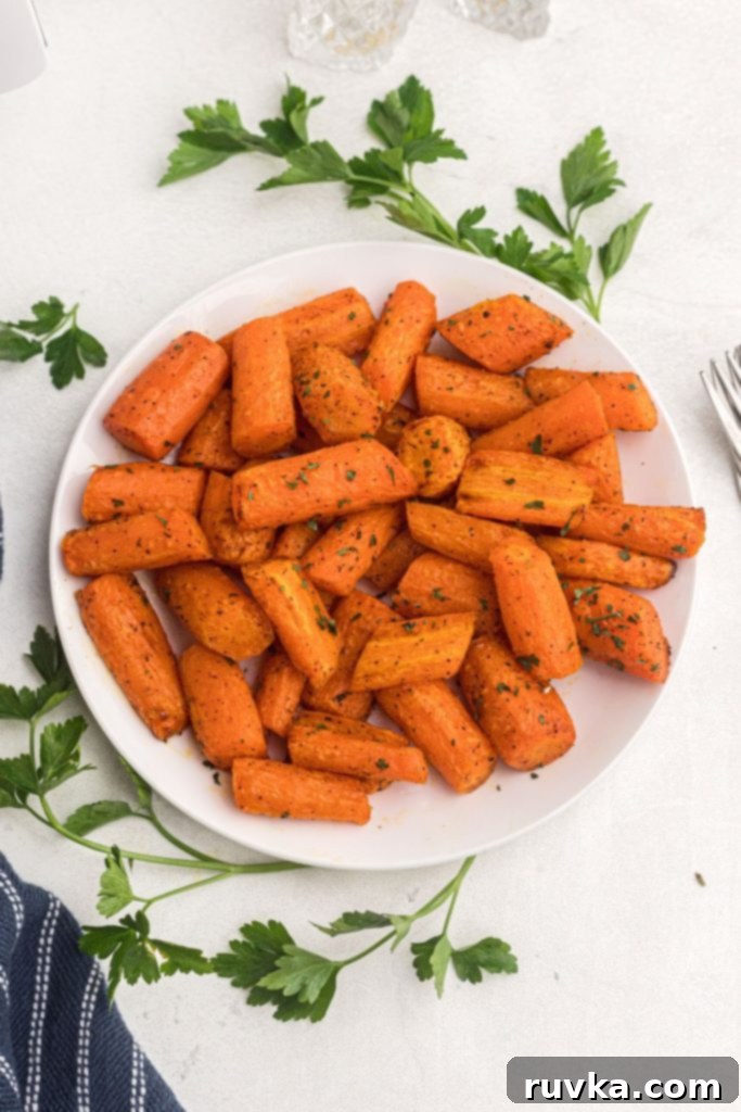 Golden Air Fryer Carrots 2 Juicy orange carrots garnished with parsley after being cooked in air fryer.