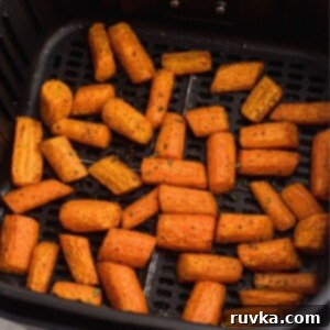 Golden Air Fryer Carrots 10 Air fried carrots in the basket after being seasoned and cooked, then garnished with parsley