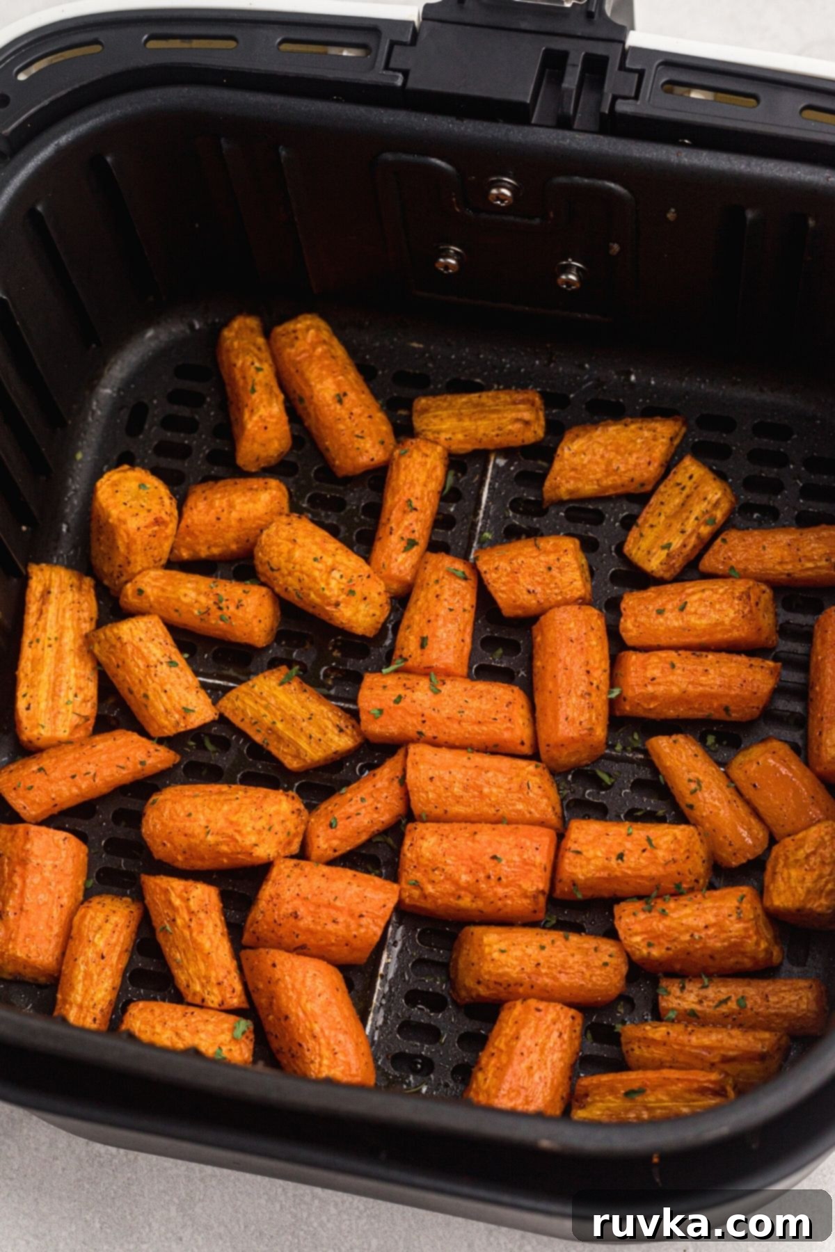 Golden Air Fryer Carrots 7 Seasoned carrots cooked in the air fryer basket.