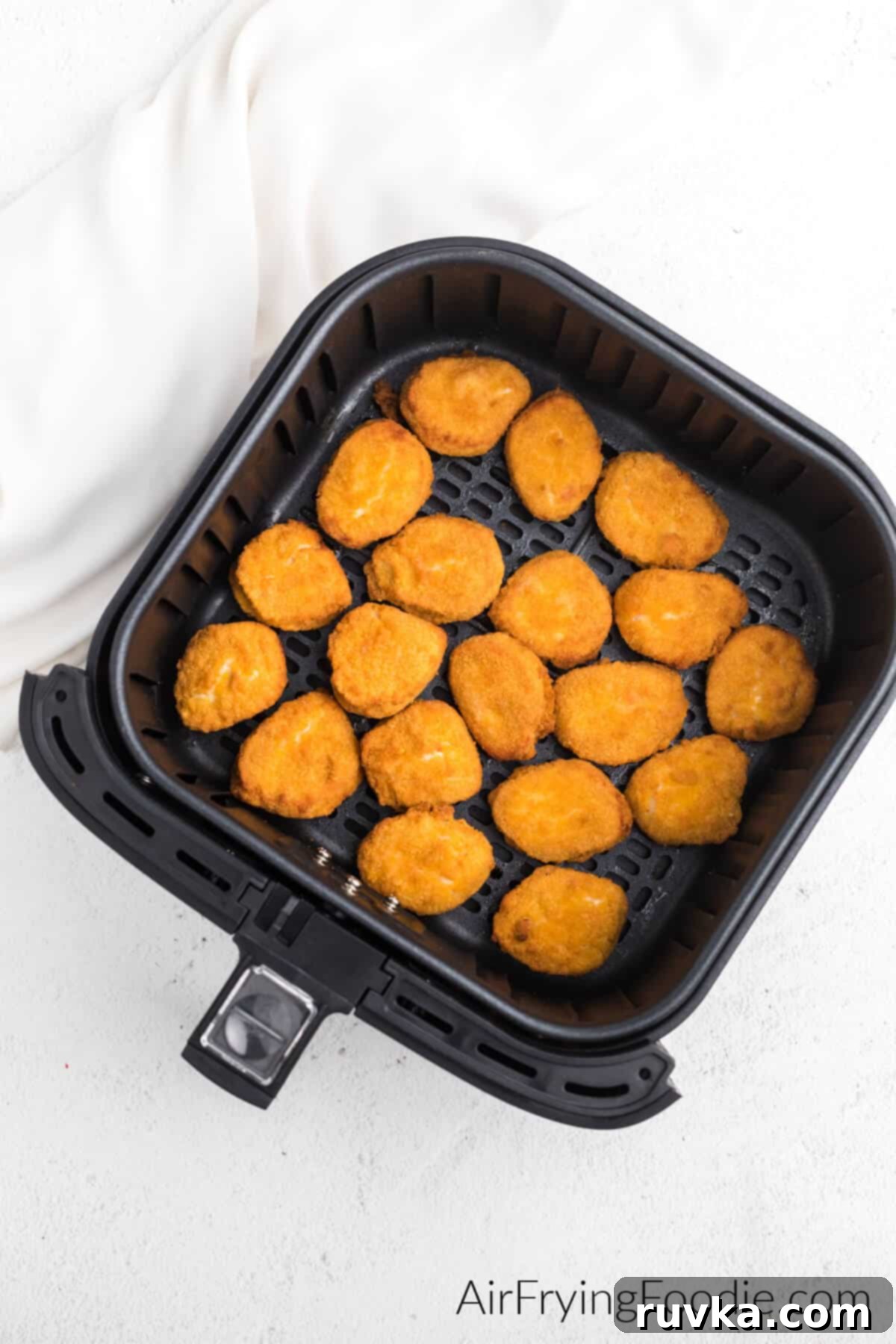 Golden Air Fryer Nugget Perfection 3 A close-up shot of frozen chicken nuggets, ready to be cooked in an air fryer, showcasing their uniform shape and breading.