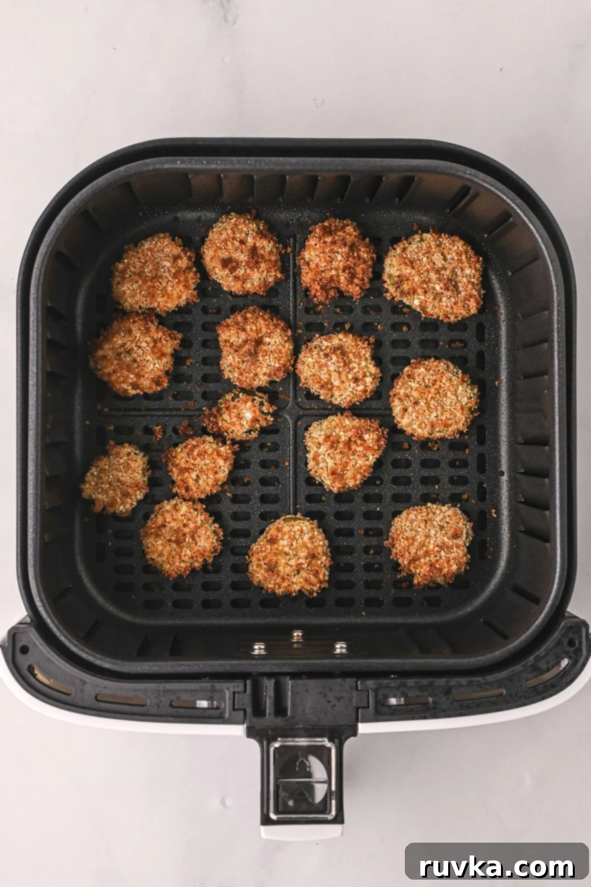 Crispy Air Fryer Fried Pickles 7 Crispy golden fried pickles, freshly cooked in the air fryer basket, ready to be served.