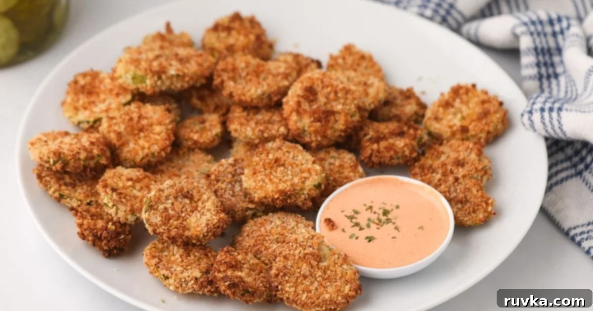 Crispy Air Fryer Fried Pickles 8 A basket full of perfectly cooked air fryer fried pickles, ready to be enjoyed with dipping sauce.