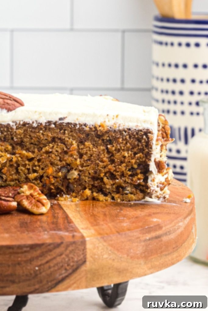 Air Fryer Carrot Cake Delight 11 Sliced carrot cake on a wooden cake stand