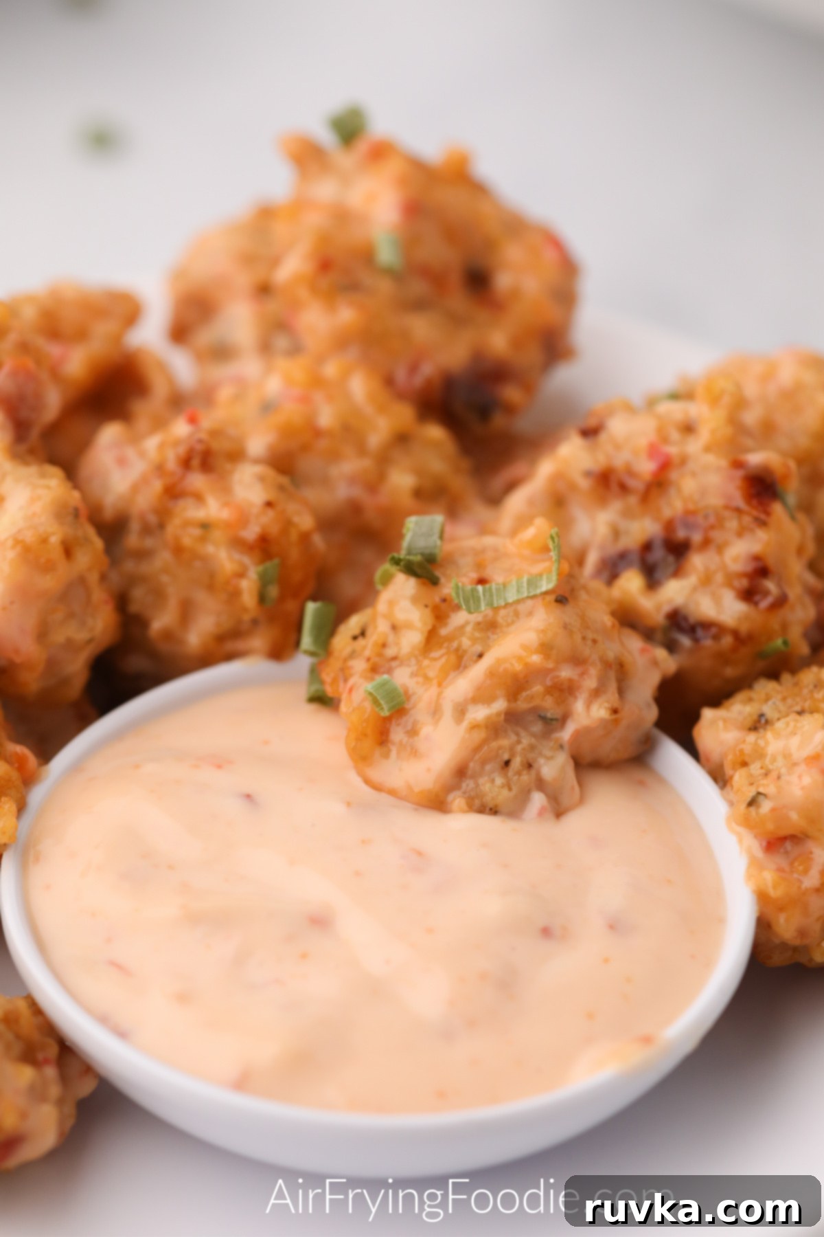 Crispy Air Fryer Bang Bang Shrimp 7 air fried bang bang shrimp ready to dip into dipping sauce and eat.